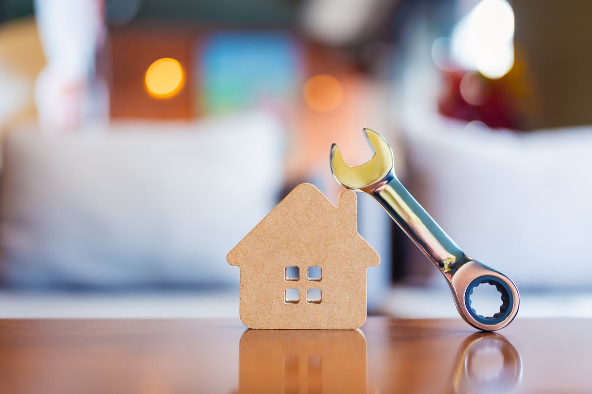 House model with wrench representing home repair and improvement services